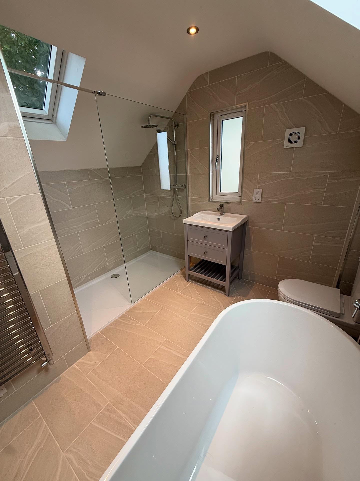 Loft shower room with walk-in glazed shower and rooflight