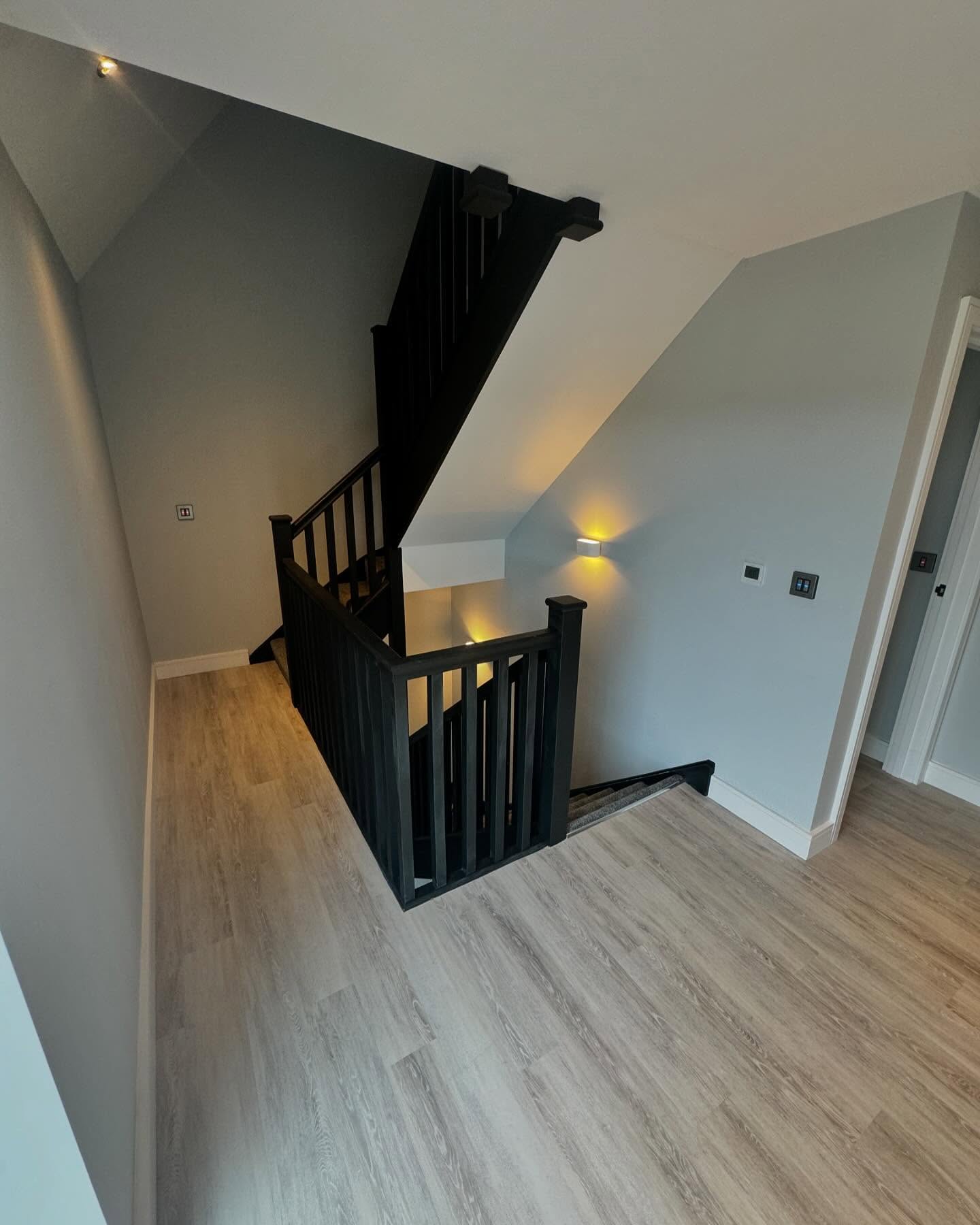 First floor landing with dark stained newels, spindles and coombed ceiling