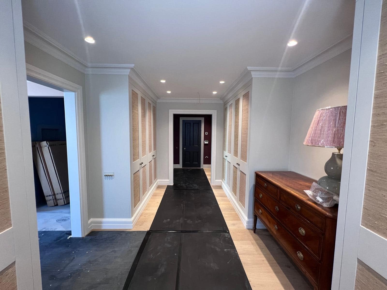 Panelled hallway with full-height fitted cupboards and cornice