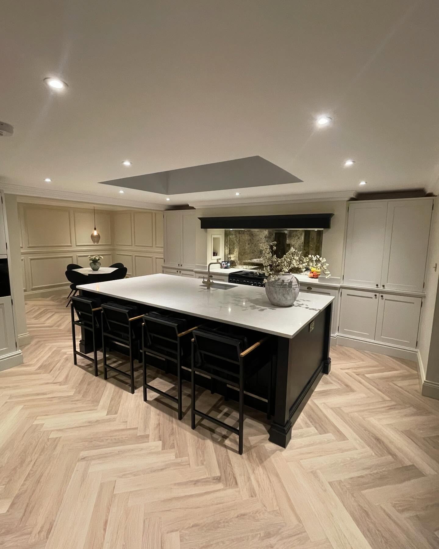 Painted in-frame kitchen with large island, wall panelling and flush rooflight