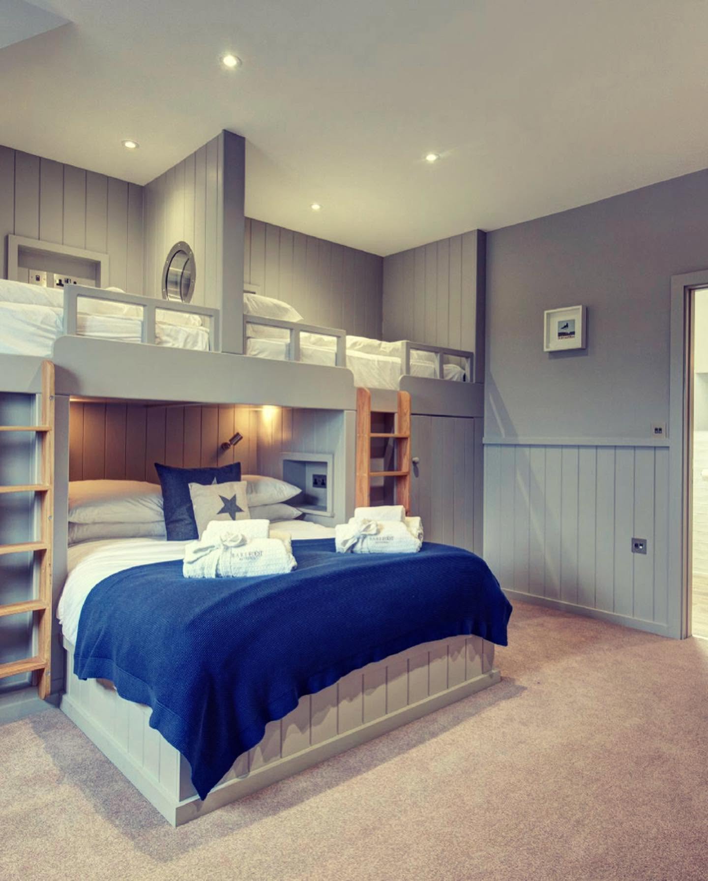 Bespoke bunk room with painted tongue and groove panelling and oak ladders