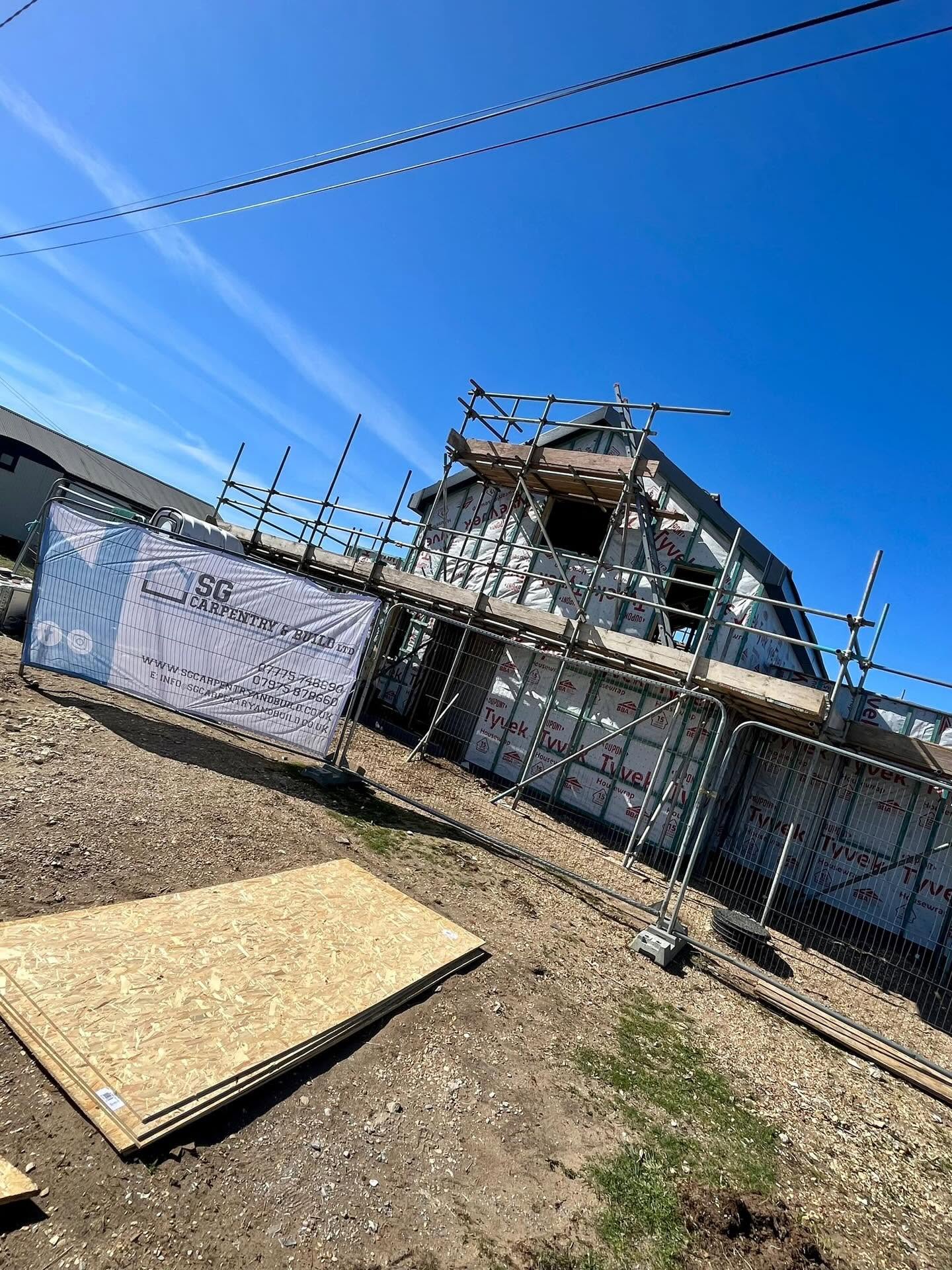 Timber frame new-build house under scaffold with breathable membrane in place