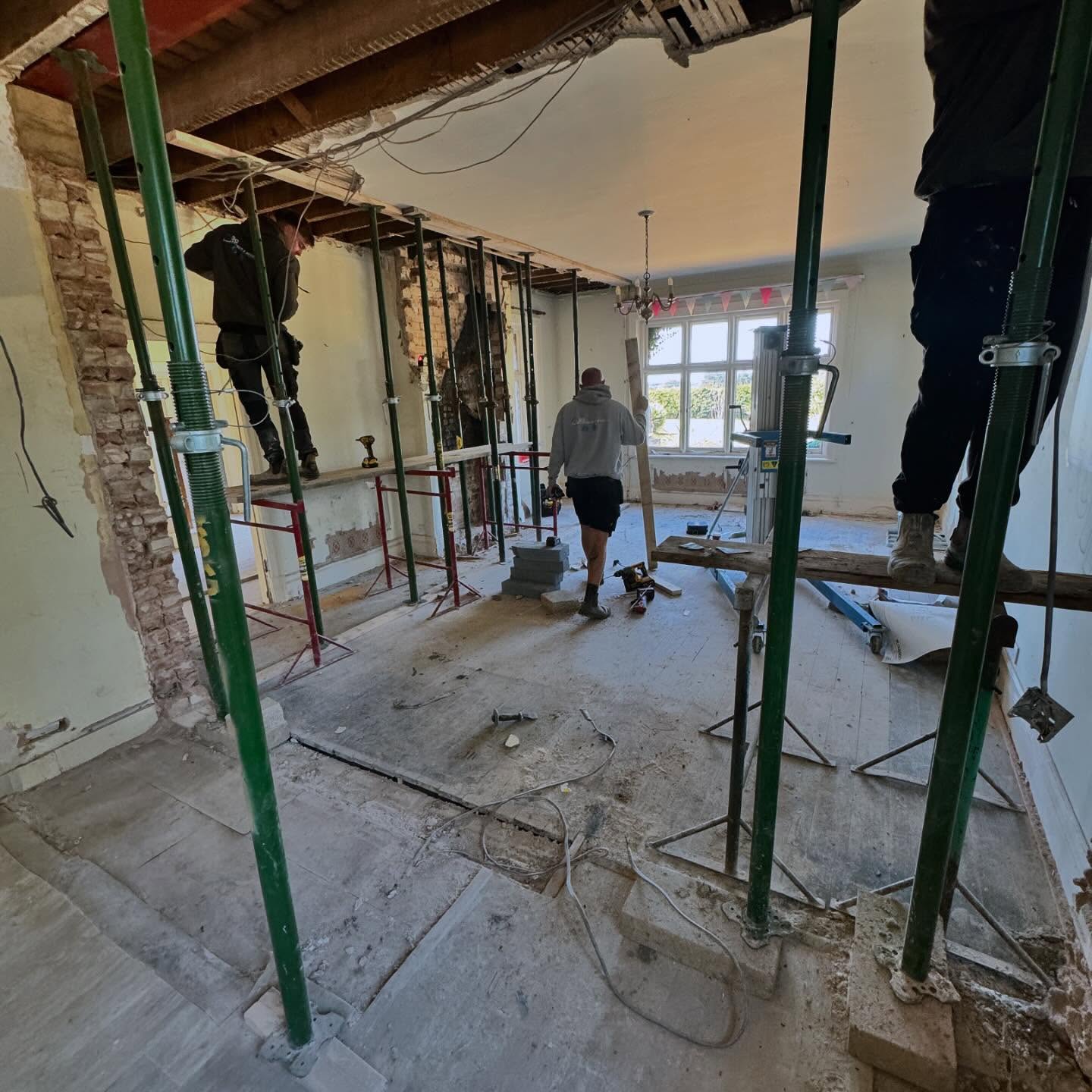 Propped structural opening being formed through a load bearing wall