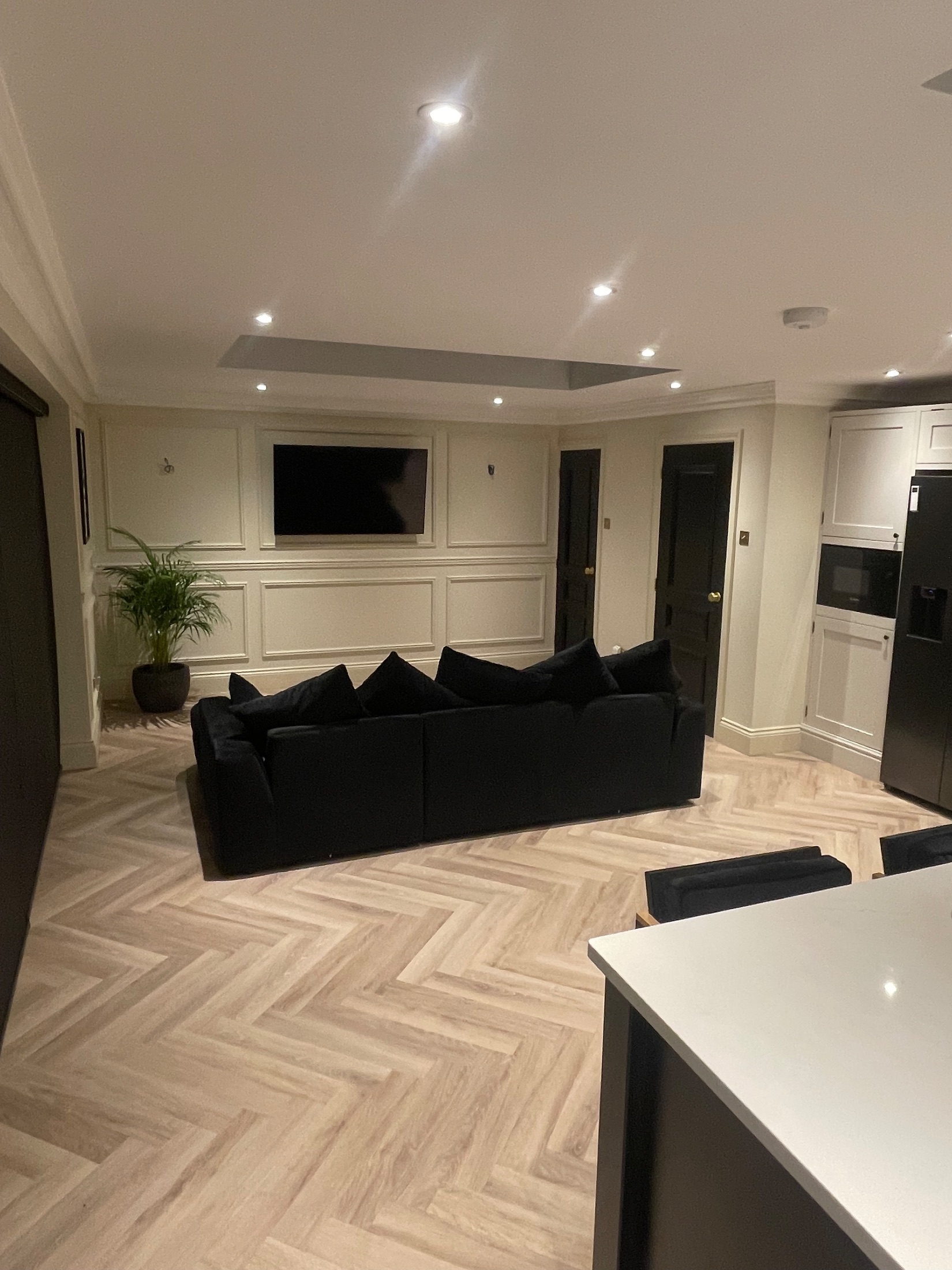 Brick garden room extension with black bifold doors open onto a porcelain terrace
